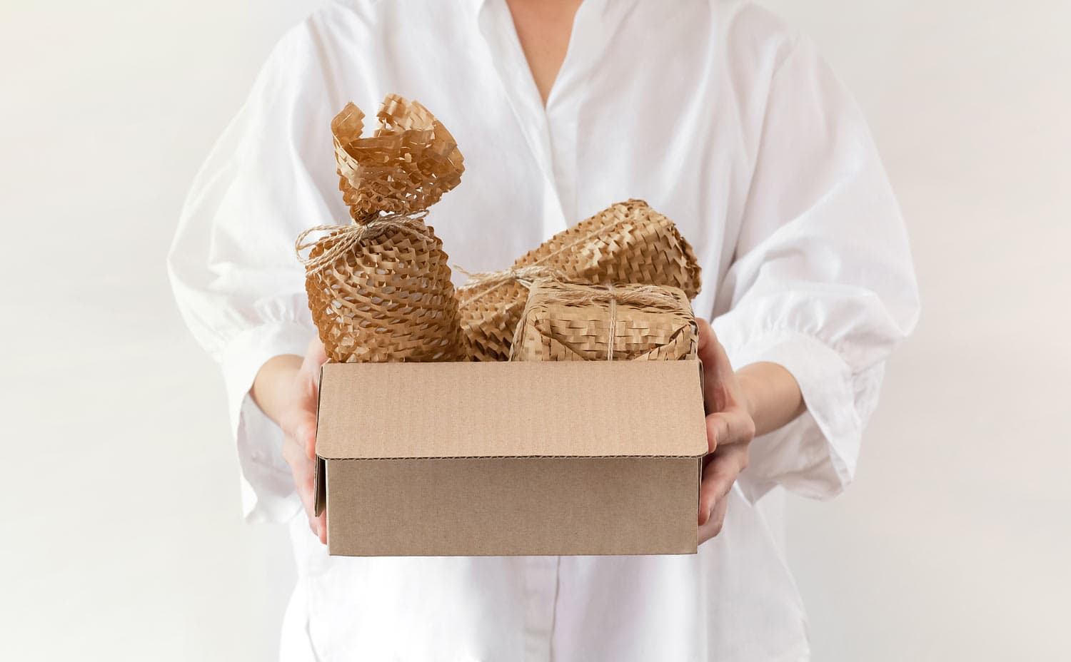 Woman,Holding,A,Box,Wrapped,With,Environmental,Friendly,Paper,Bubble