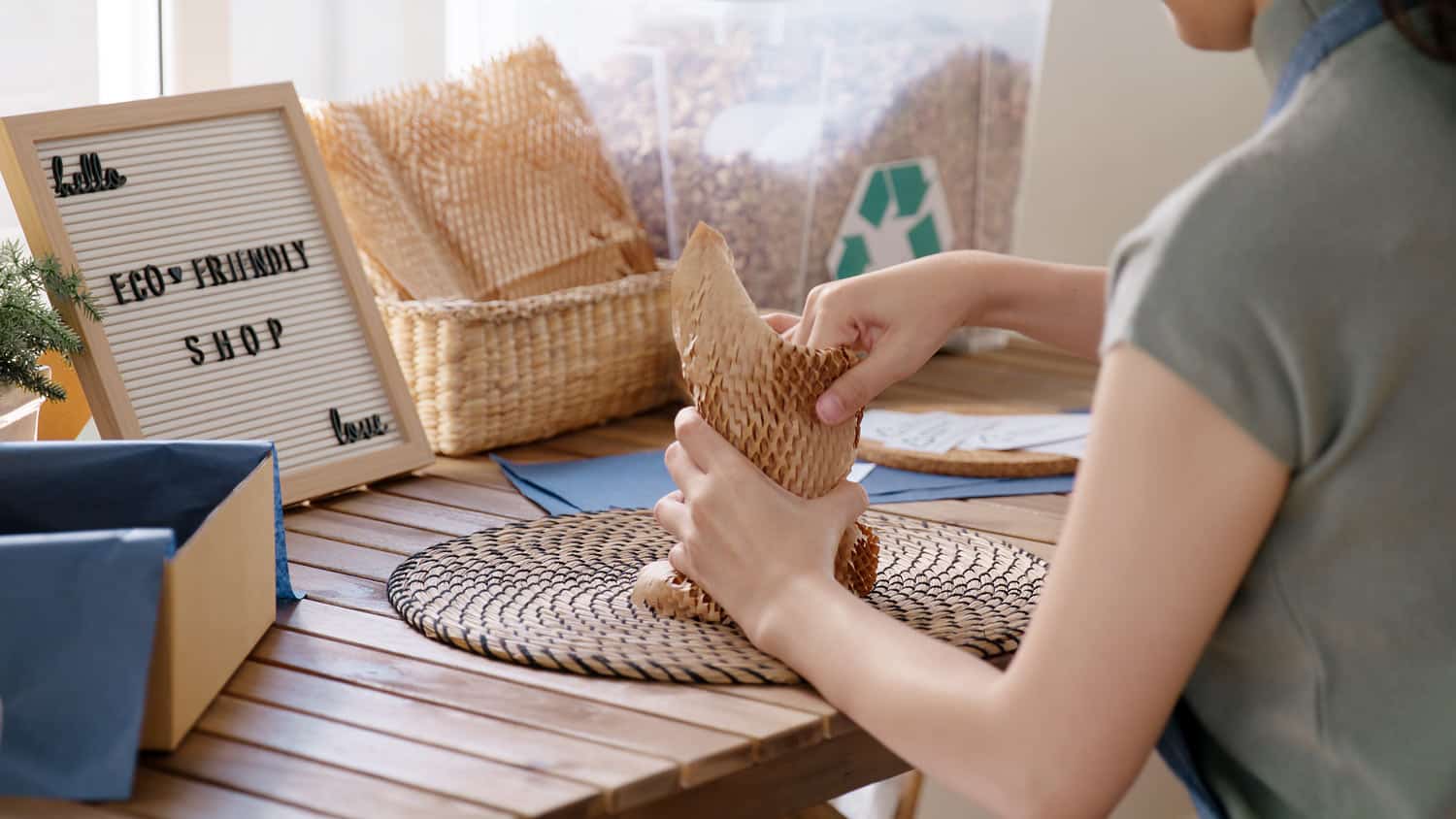 woman packing with paper bubble wrap