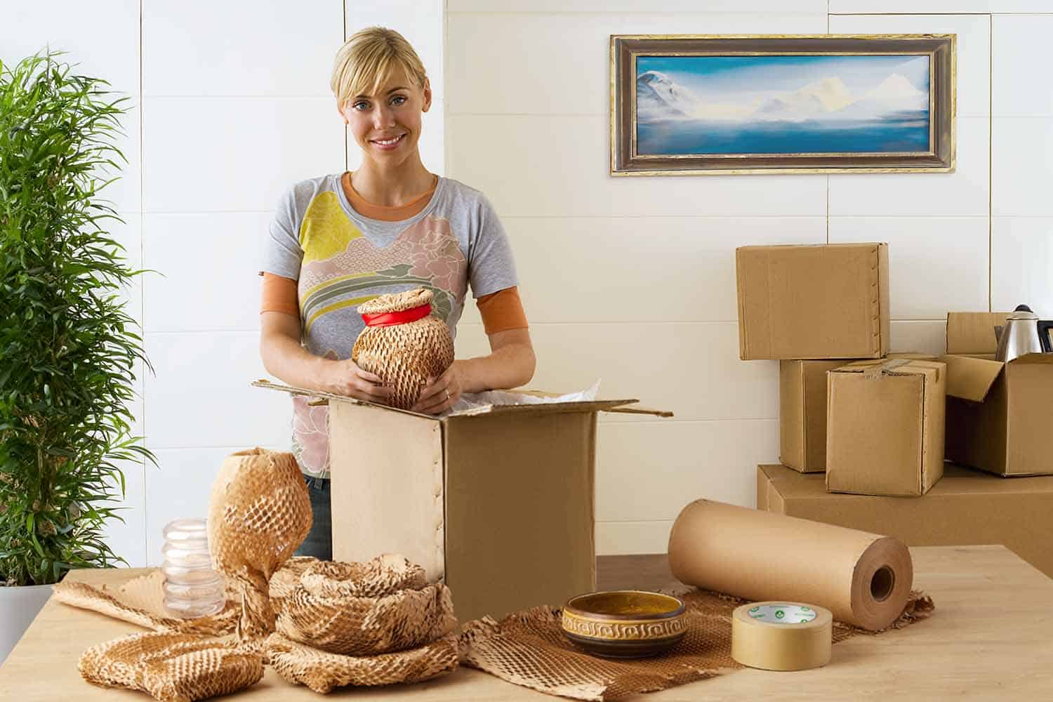 woman packing with Biodegradable Packing Materials: Moving Paper