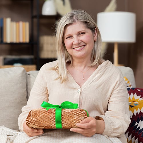 woman holding a gift packed with Honeycomb Packing Paper, Packing Wrap,
