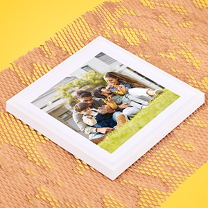 photo frame lying on stretched paper for wrapping fragile items